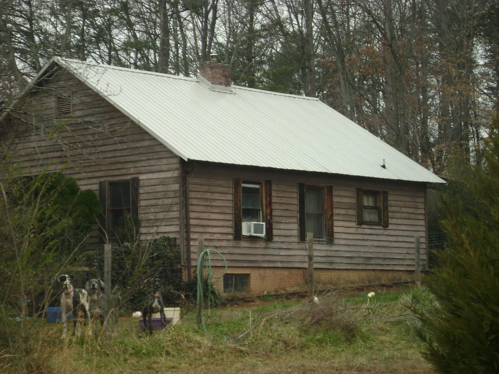 White metal roof on an old wood sided farmhouse, from a Metal Roof Installation job in Weyers Cave